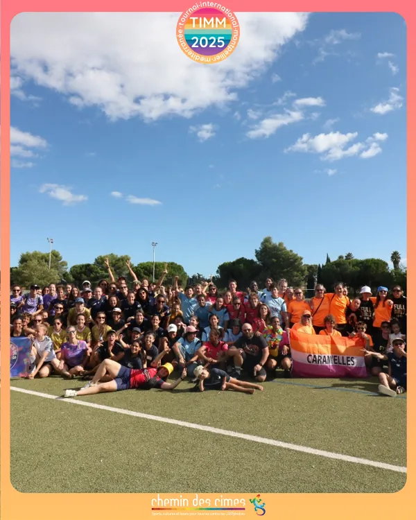 Les équipes de football FLINTA réunies sur le terrain pour une photo de groupe, avec la bannière des Caravelles.